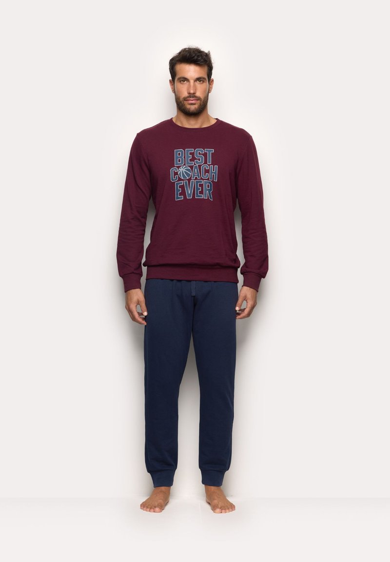 Maroon long-sleeve shirt with "BEST COACH EVER" text and a basketball graphic, paired with navy blue sweatpants. Soft fabric, relaxed fit.