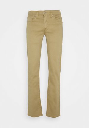 Homokszínű, slim fit farmernadrág, pamutból készült, öt zsebbel, övhurkokkal, cipzárral és gombos záródással.