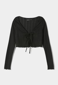 Černý cropped top s dlouhými rukávy, V-krkem a detailem vázání vpředu. Vyrobený z texturovaného, vroubkovaného materiálu s jemným leskem.