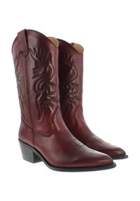 Red leather cowboy boots with pointed toes, decorative stitching, and a low stacked heel. Features intricate embossed designs on the shaft.