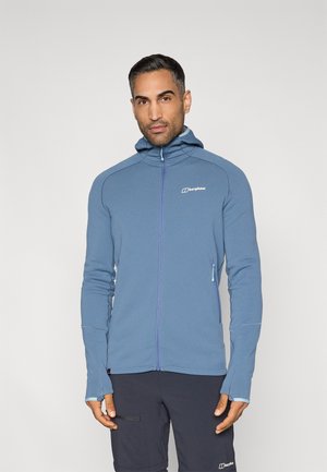 Veste polaire bleu à fermeture éclair avec capuche, équipée d'une fermeture contrastante, logo sur la poitrine et passe-pouces aux poignets. Matière douce et légère.