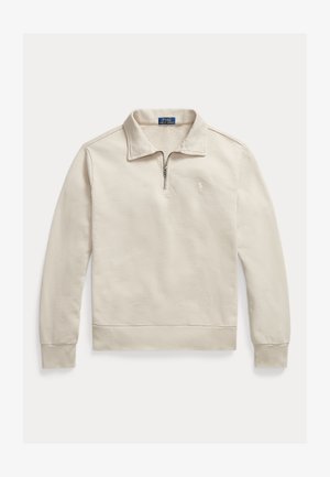 Svetlo béžový pulóver s dlhým rukávom, štvrťzipsovým golierom a malým vyšívaným logom na ľavej strane hrudníka.