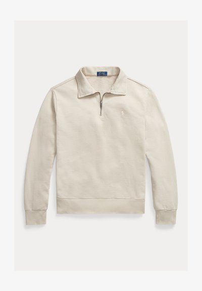 Μπεζ ανοιχτόχρωμο μακρυμάνικο πουλόβερ με γιακά στο μισό φερμουάρ και μικρό κεντημένο λογότυπο στο αριστερό στήθος.