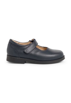 Navy leather Mary Jane shoe with a rounded toe, scalloped edge, and adjustable strap, featuring a low black rubber sole.