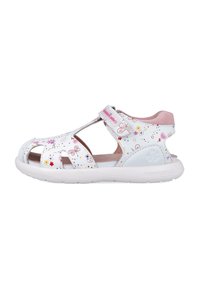 Sandalias blancas para niños con recortes, patrones de flores y mariposas, correa de velcro, interior acolchado en rosa y suela de goma blanca.