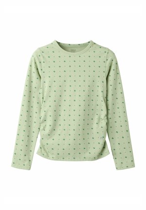 Chemise vert clair à manches longues avec petits motifs d’ancres vert foncé répartis uniformément sur le tissu.