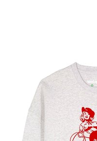 T-shirt en coton gris avec un col rond et des épaules tombantes. Présente une impression graphique rouge d'une femme avec un lasso. Design simple et décontracté.