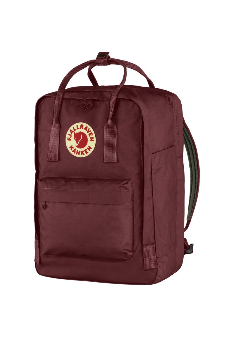 Red textile backpack with a rectangular shape, featuring a front pocket, two top handles, and an adjustable strap. Logo on the front.