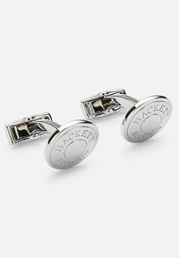 Silver cufflinks with a circular design. Engraved "HACKETT" and "LONDON" around a central disc, featuring a polished, reflective finish.