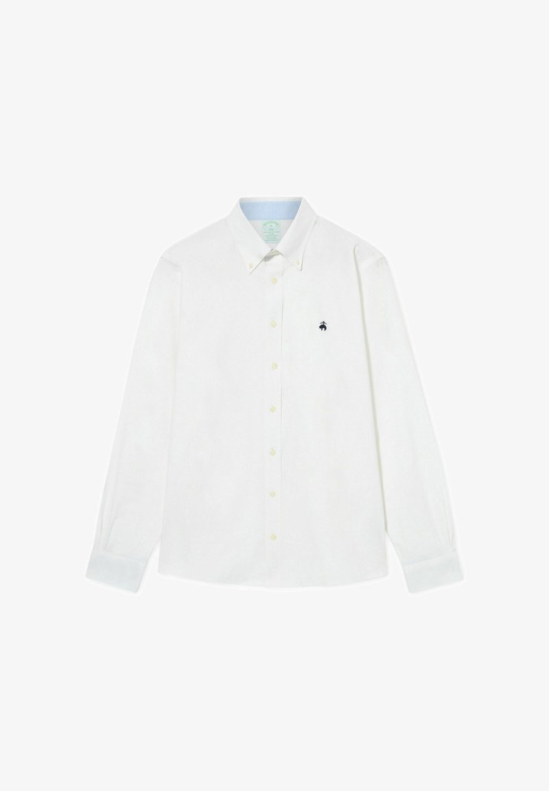 Bílá košile s dlouhým rukávem z měkké tkaniny s límcem na knoflíky, zdobená žlutými knoflíky a malým modrým logem na levé části hrudi.