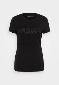 Camiseta de algodón negra de manga corta, con escote redondo, que presenta el logo "GUESS LOS ANGELES" en rhinestones en el pecho.