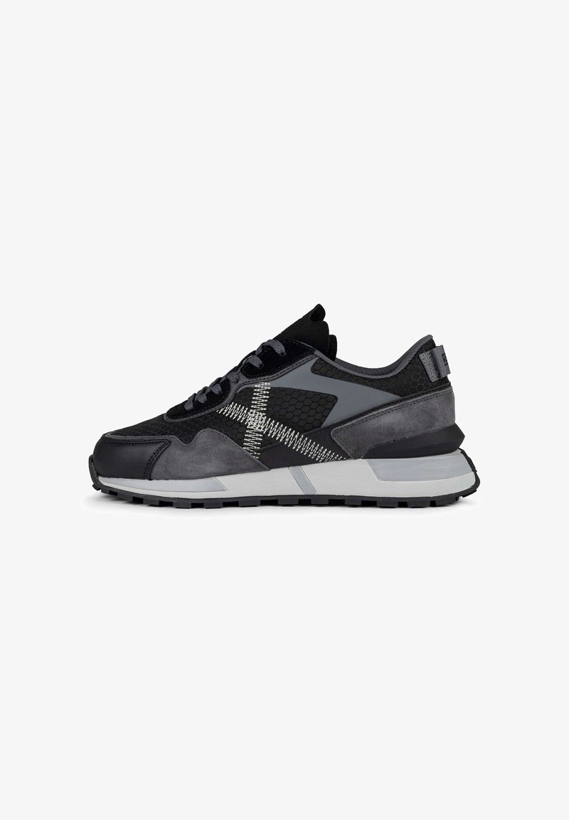 Black and gray sneaker features mixed materials, including suede and mesh. The design has contrasting textures, a patterned side, and a sturdy sole.