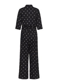 Combinaison noire avec motif losange beige, manches trois-quarts, col et pantalons larges, vue de dos.