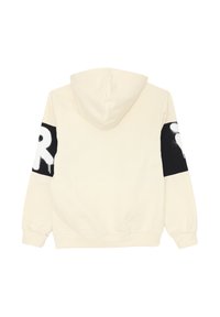 Felpa color crema con patch rettangolari neri sulle maniche, caratterizzati da lettere in stile spray bianco, vista da dietro.