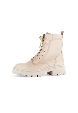 Beige leather ankle boots with a round toe, lace-up front, and a chunky white sole. Features a pull tab at the back and textured finish.