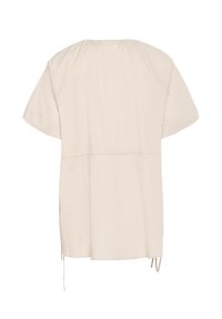 Beige kortærmet top med samlet halsudskæring og snorejusteringer i siden. Fremstillet af let, glat stof med en løs pasform.