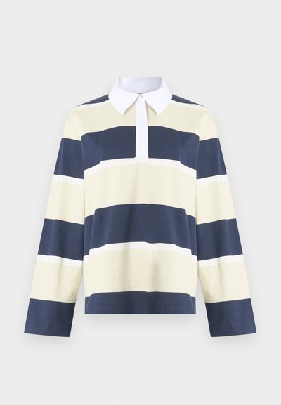 Tricou polo cu mâneci lungi, cu dungi orizontale în albastru marin, crem și alb. Guler alb și din material moale din bumbac. Design cu tiv drept.