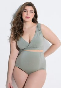 Mátově zelený bikinový komplet s hlubokým výstřihem do V a vysokými kalhotkami. Hladká tkanina s překříženým detailem uprostřed.