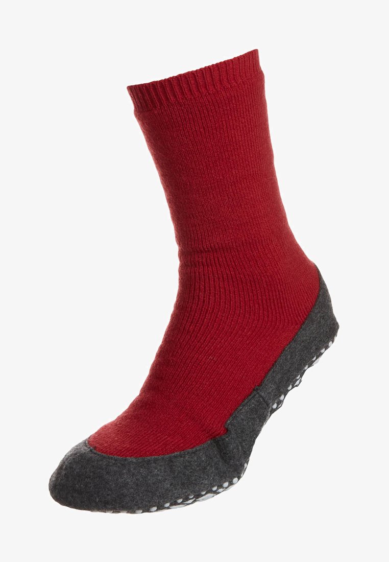 Red knit sock with a textured gray felt sole, featuring white rubber dots for grip. The sock is mid-calf length with a ribbed design.
