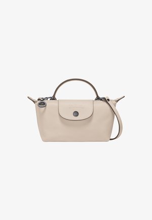 Beige leather handbag with rounded top handle, detachable shoulder strap, and flap closure. Features embossed logo and metal accents.