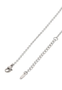 Zilveren metalen ketting met een kreeftsluiting. Bevat ovale schakels met een gladde afwerking en een klein ovaal label dicht bij de sluiting.