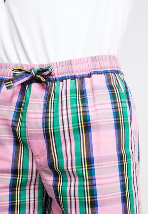 Shorts en vichy multicolores avec des rayures roses, vertes, noires et bleues. Taille élastique avec un détail à nouer et texture lisse.