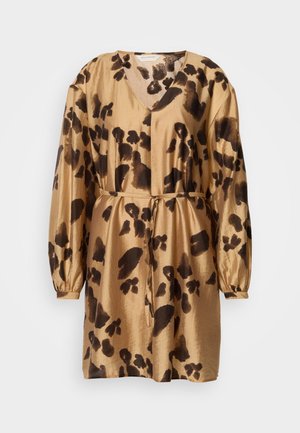 Rövid ujjú, V nyakú ruha aranyszínű selyem anyagból, barna leopárdmintával, a deréknál passzoló övvel megkötve. Puha tapintású és lágy sziluettű.