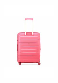 Pink hard-shell suitcase with vertical ridges, white retractable handle, and four spinner wheels for easy mobility. Zippered closure.