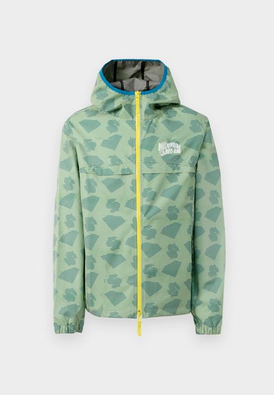 Šviesiai žalia lietpaltis su geometriniu raštu, geltonu užtrauktuku ir gobtuvu, turi vidinį pamušalą su pilku kvadratiniu raštu.