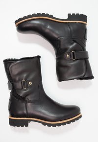 Black leather ankle boots with a rounded toe, gold hardware accents, faux fur lining, and a lug sole for traction.