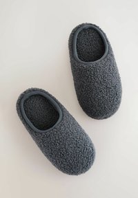 Szare polarowe kapcie z miękką, teksturowaną powierzchnią i zaokrąglonym czubkiem. Elastyczne wykończenie wokół otwarcia dla pewnego dopasowania.