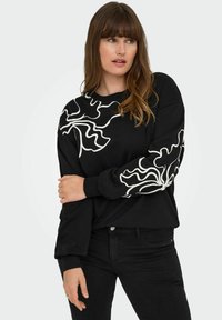 Black sweatshirt featuring abstract white wavy patterns on the shoulder and sleeve. It has a crew neckline and ribbed cuffs.