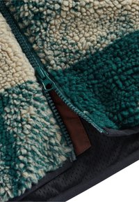 Fleece zip-up jacket featuring teal and cream color blocks, textured surface, contrasting brown zipper accent, and black mesh lining.