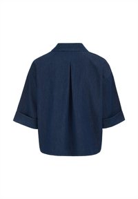 Sötétkék farmering, gallérral, rövid, felgöngyölt ujjakkal és hátsó redőzött részlettel. Simább textúra, laza, oversize fazon.