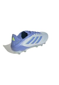 Light blue soccer cleat with purple accents, textured upper, three striped design, and clear studs for traction. Features a padded heel.