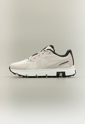 Zapatilla baja de color beige claro con detalles en negro, suela texturizada, parte superior de malla, cierre delantero con cordones y logo "J.LINDEBERG" en el lateral.