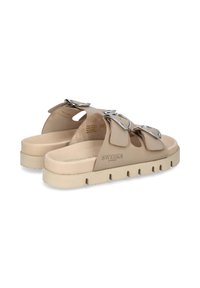 Beige sandals made of synthetic material, featuring two wide straps with decorative buckles, a thick sole with a textured surface, and branding.