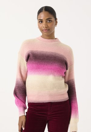 Pull en tricot avec un dégradé de rose clair à violet, à texture côtelée et col montant. Modèle associé à un pantalon bordeaux.