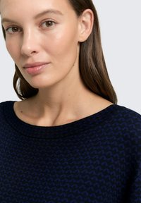 Maglione a maglia blu navy con un sottile motivo a zigzag, scollatura ampia e superficie liscia, caratterizzato da una vestibilità comoda e uno spessore medio.