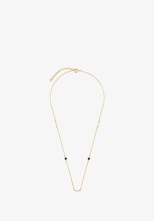 Złoty naszyjnik z delikatnym łańcuszkiem, w którym naprzemiennie występują czarne i białe okrągłe koraliki. Regulowana długość z zapięciem.