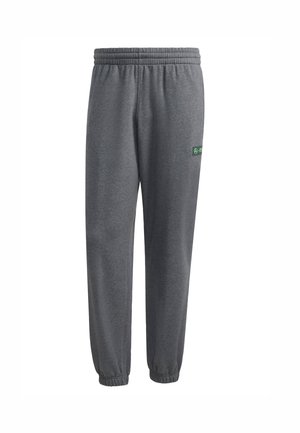 Grijze sportieve joggingbroek gemaakt van zachte stof, met een elastische tailleband, geribde manchetten en een klein groen logo aan de zijkant.