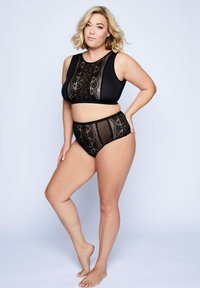 Black lingerie set featuring a crop top with lace overlay and high-waisted briefs. Smooth fabric complemented by intricate lace detailing.