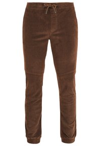 Brown corduroy joggers with elastic waistband and drawstring. Tapered design with elastic cuffs and vertical seams for a textured look.