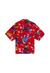Short-sleeved shirt in vibrant red fabric featuring an abstract multicolor pattern of shapes and strokes throughout the design.