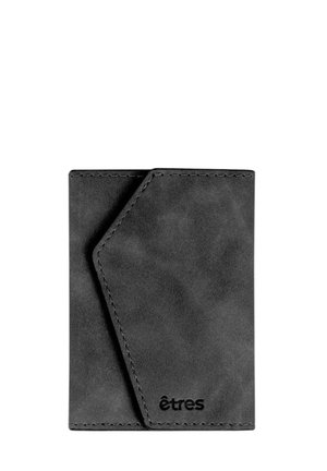 Black leather cardholder with a minimalist design, featuring a diagonal flap and stitched edges. Includes embossed brand logo.