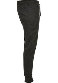 Grijze sweats gemaakt van zachte stof, tapered ontwerp met een elastische tailleband, verstelbare trekkoord en zijzakken.