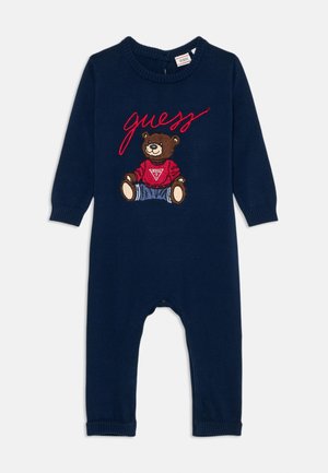 Navy blue knitted romper featuring a bear graphic in a red sweater with embroidered details, ribbed neckline, and cuffs.
