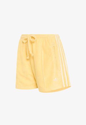 Žlté froté šortky s pásikom na stiahnutie v páse, bielymi bočnými pruhmi, prednou zipsovou vreckom a malým bielym logom.