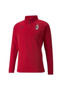 Punane pikad varrukad pullover, millel on veerand-tõmblukk, Puma must logo ja AC Milano embleem rinnal. Sile kangas.