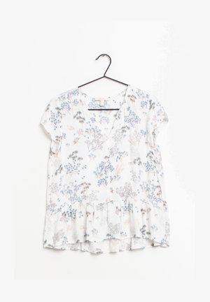 Short-sleeve, white floral blouse with delicate blue, pink, and gray patterns. Features a v-neckline and a peplum hem. Lightweight fabric.